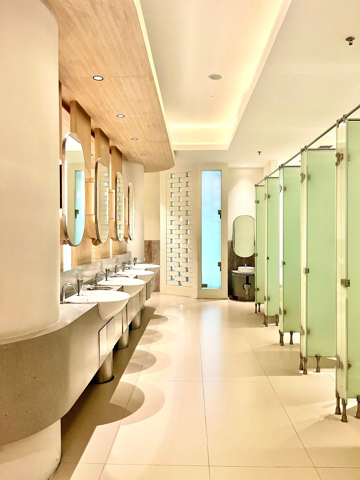 High-use public washroom with multiple basins and cubicles