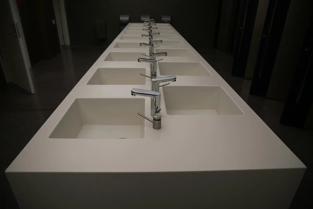 Rows of faucets displayed over basins