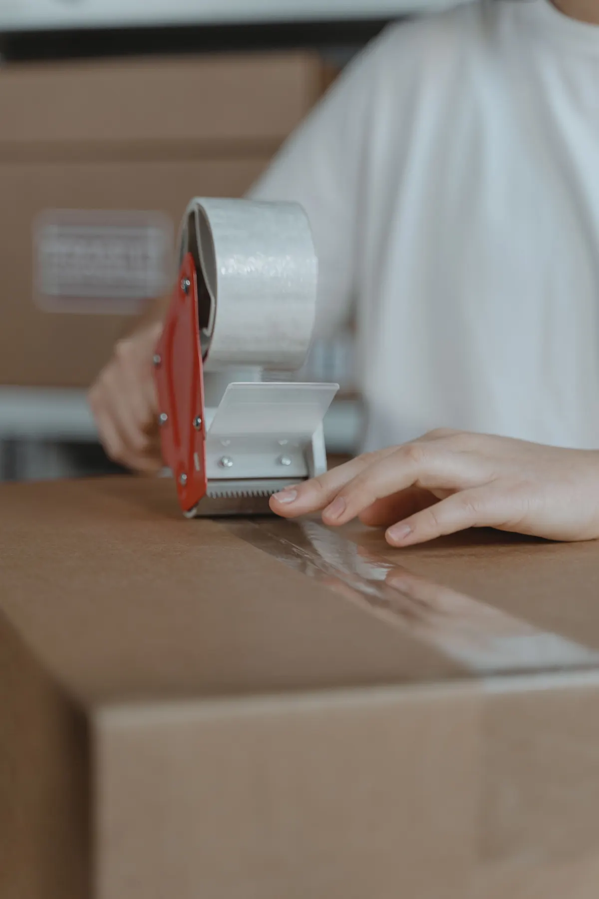 Carton being labeled and sealed for packing