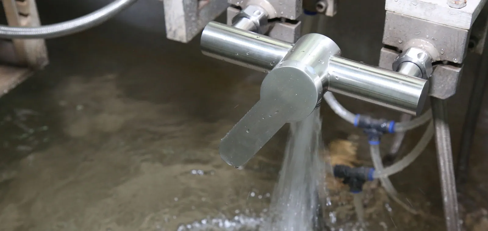 Bathroom faucet under water-flow testing at a VeriBath quality-control station