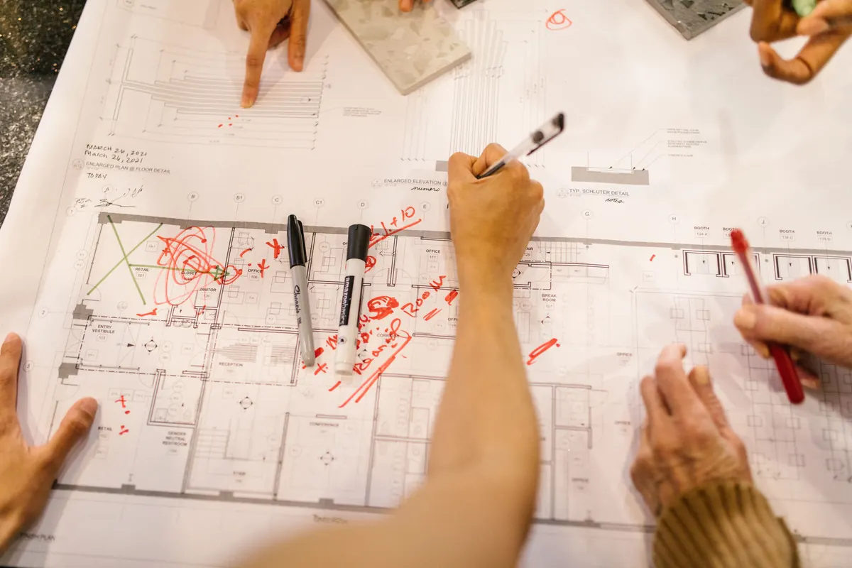 Team reviewing a building plan for a project package