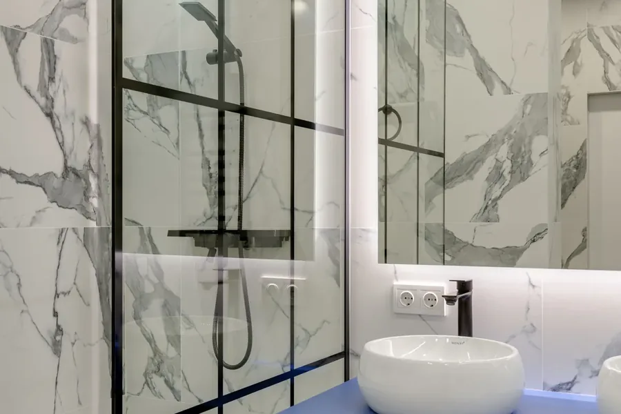 Apartment bathroom setting with shower and basin fixtures