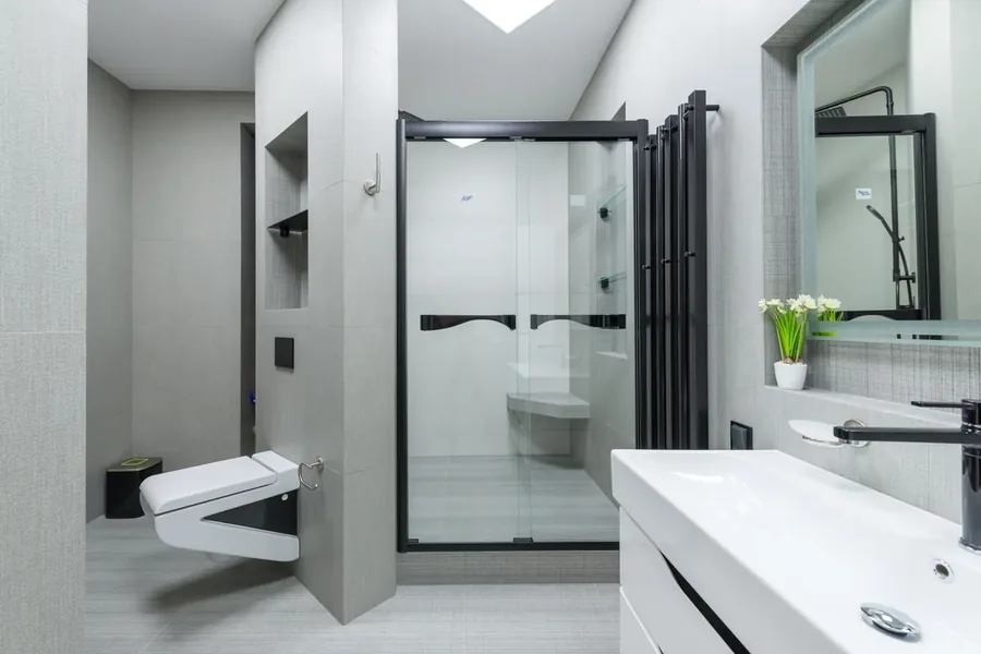 Residential bathroom setting with shower, basin, and support rail